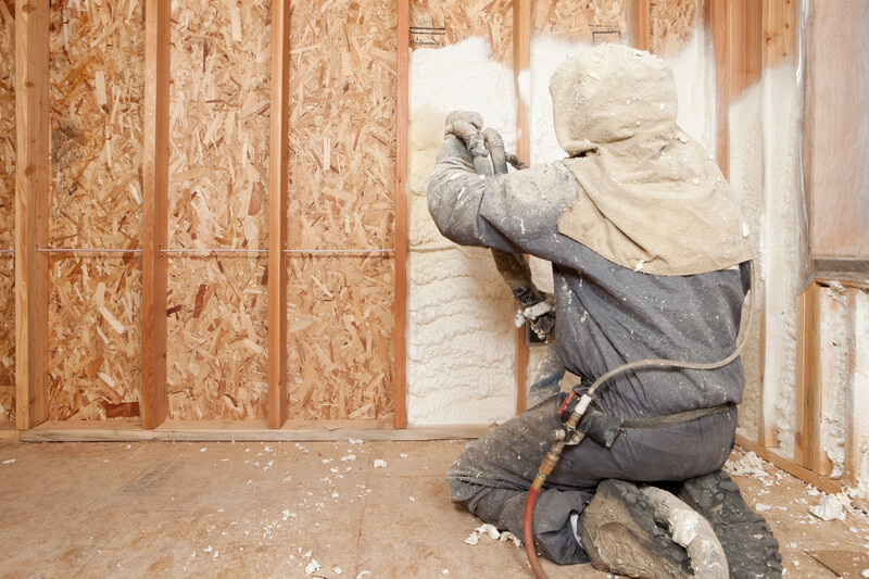 Worker-Spraying-Foam-Insulation-Wall-Studs-IStock_185126412