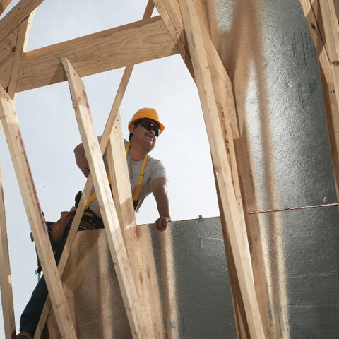 construction worker seen through some framing