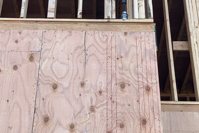 This photo shows a 2-inch o.c. nailing pattern at the shear wall boundary member. Because this building is using tie-down rods with concentric compression posts, the nailing pattern is repeated on either side of the rod.